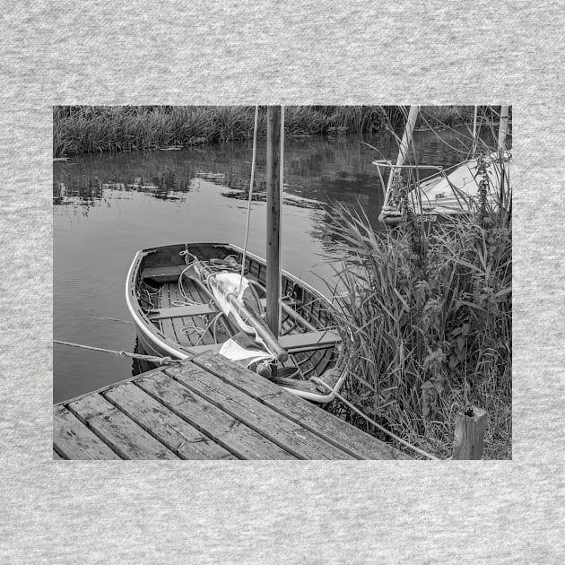 Small wooden boat moored to a quay heading on the Norfolk Broads by yackers1